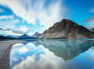 Mountains reflecting in Bow Lake along the Icefields Parkway