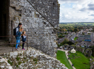 People walking towards Corfe Castle's Outer Gatehouse