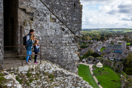 People walking towards Corfe Castle's Outer Gatehouse